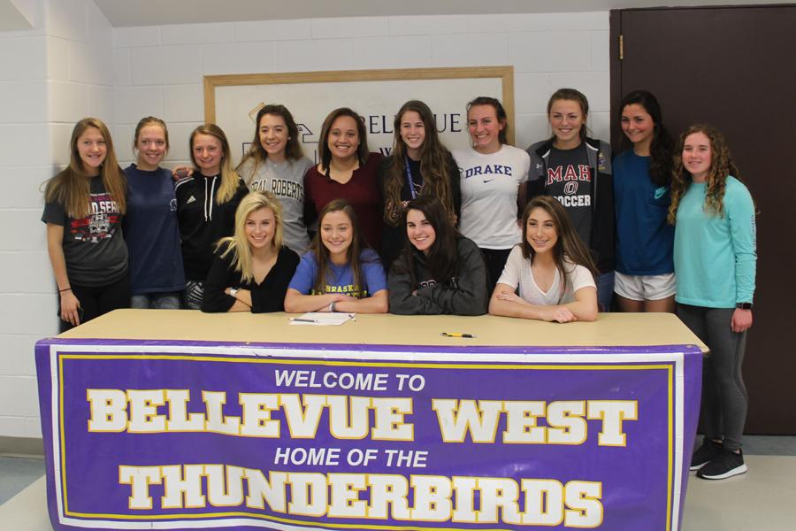 Senior Megan Cook poses with the Bellevue West girl's soccer team after signing with the University of Nebraska-Kearney.