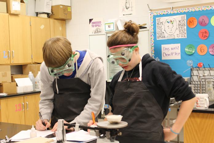 Sophomores Jason Wisenbaher and Kailee Wills practice their chemistry skills during a science lab.  Photo by Courtney Swift.
