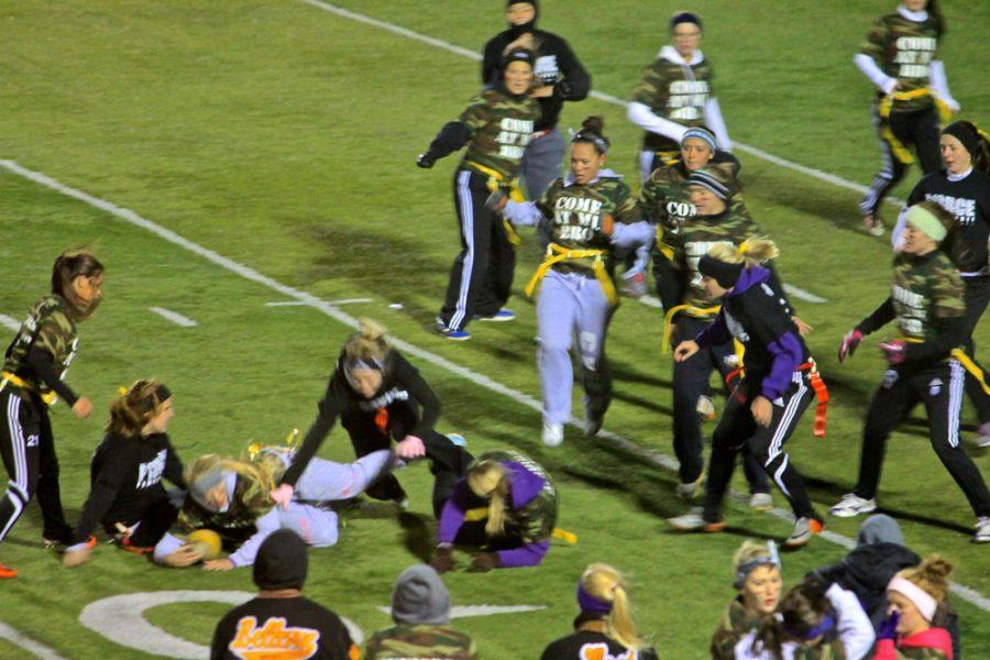 The seniors and juniors played rough and fast at the powder puff game. They were supposed to play flag football but with all the excitement going on thats not all the girls had done -- the juniors. and seniors tackled also. It wasnt about wining or losing to the girls it was all about the fun and to get inside and out of the 28 degrees outside. 
Photo by Kyle Malone.