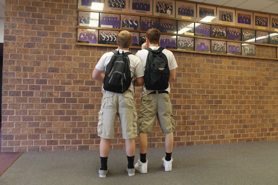Seniors James Headid and Joe Messina admire the pictures on The Fine Arts Wall of Champions while dressed as twins. Headid and Messina were among the few guys who participated in twin day. They were two of four boys dressed as twins. The other two, not pictured, were seniors Aaron Estrada and Zach Oslica These boys tired their best to support Bellevue West during spirit weeks. Photo by Emily Romero.