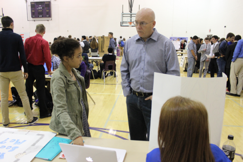 Junior Xavia Martin explains her CBL project to a visitor. Photo by Rae Rangel