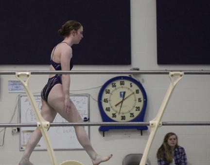 Junior Jessica Warak walks up to the diving board as she practices her dive for competition. 