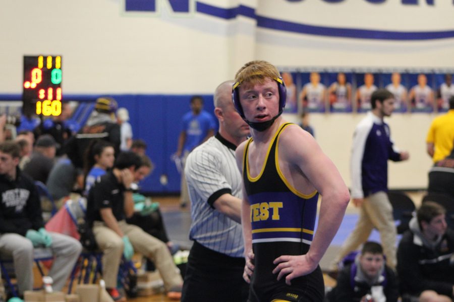 Junior Nolan Koehler looks to the Bellevue West wrestling coaches during the district tournament.