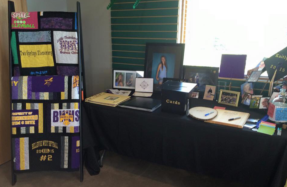 Pictures, cards, and memorable keepsakes are situated for a graduation party.