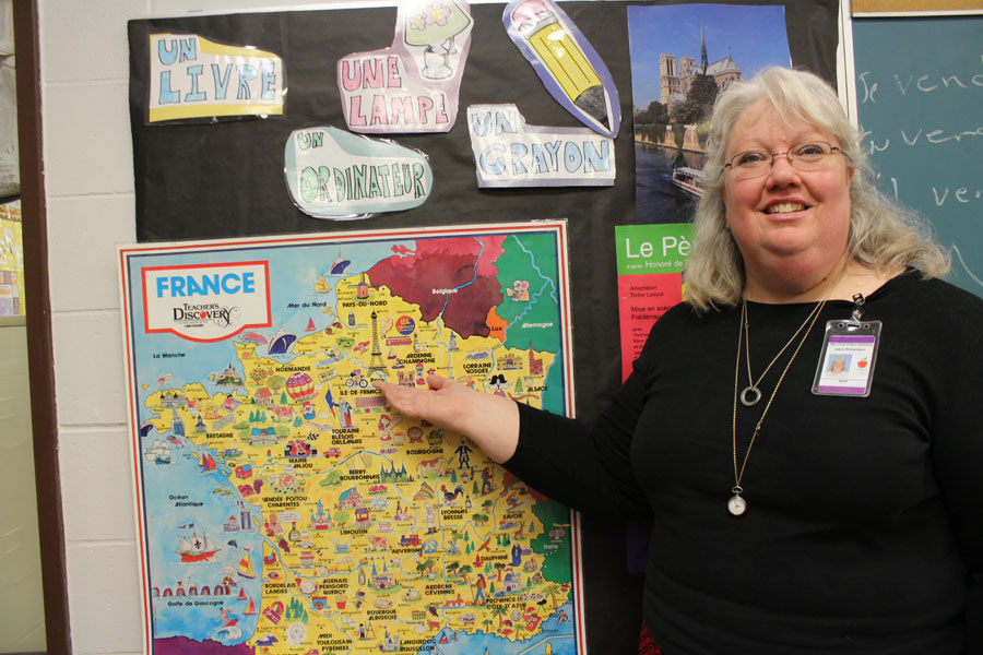 French teacher Debra Richardson points to a map of France, where she intends to travel to this summer.