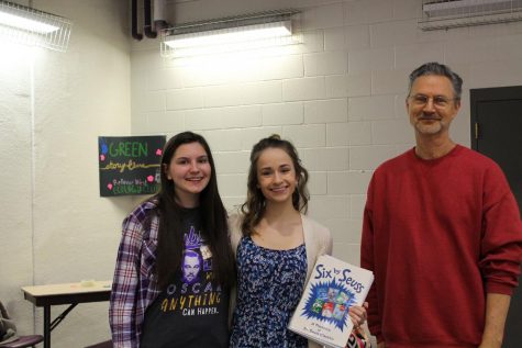 Ecology Club members juniors Kat Woerner and Alexandra Janca and the club sponsor Steve Thyberg prepare to read to children at the Sarpy County Earth Day on April 30.