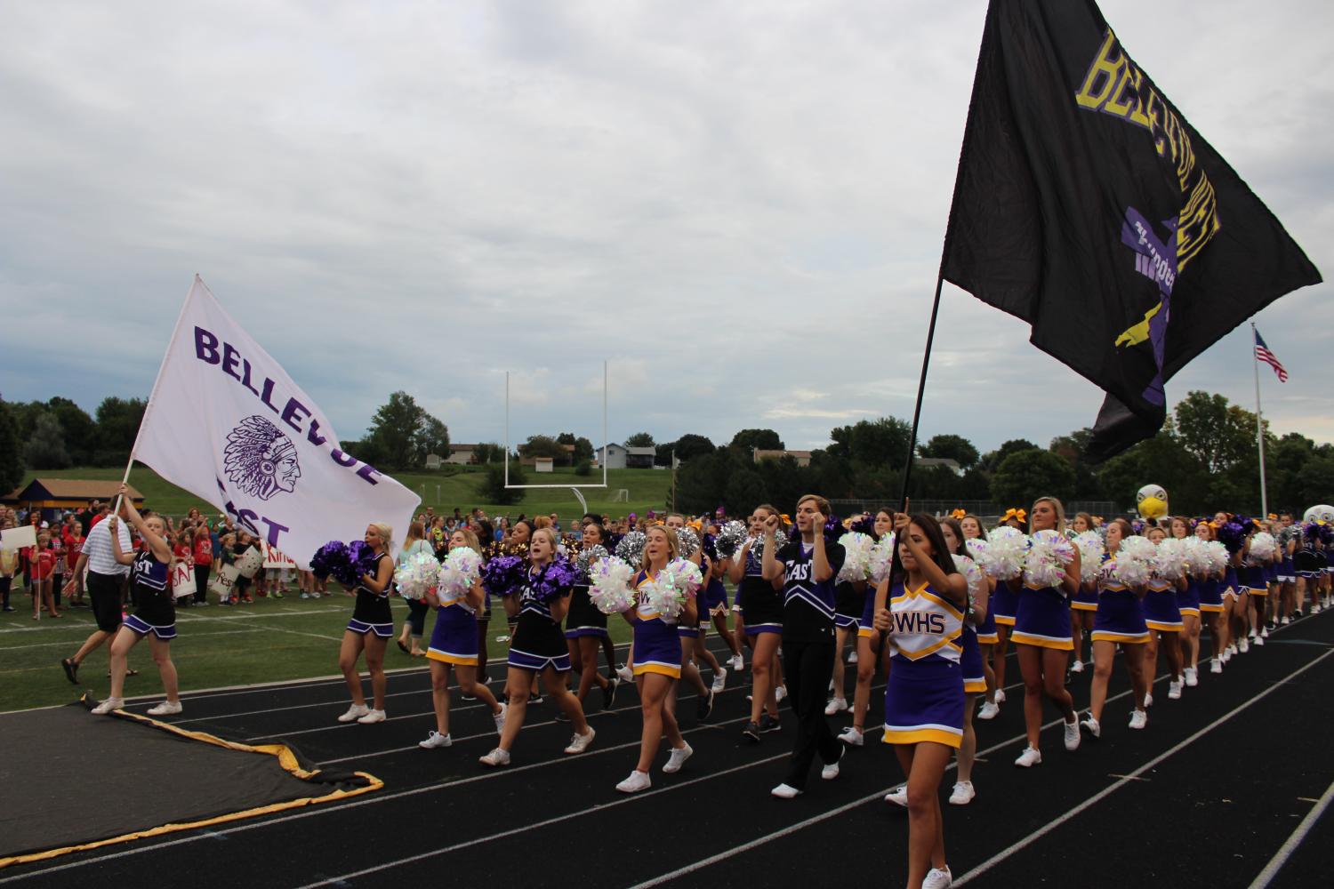 Cheerleaders and dance team members from both Bellevue West and Bellevue East walk together during the 2016 Unity Rally.