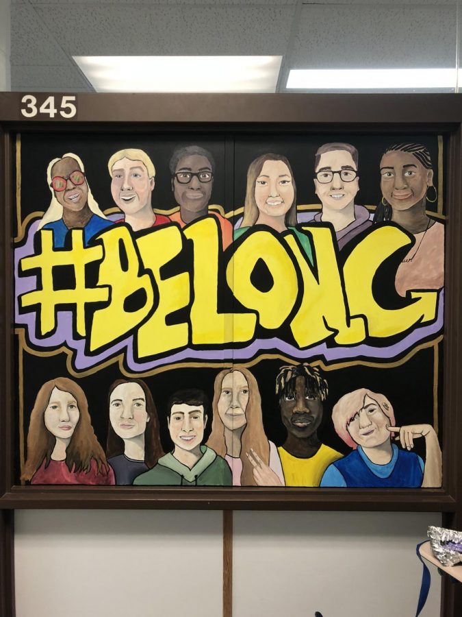 Junior Baylee Clang paints #belong mural in math hallway