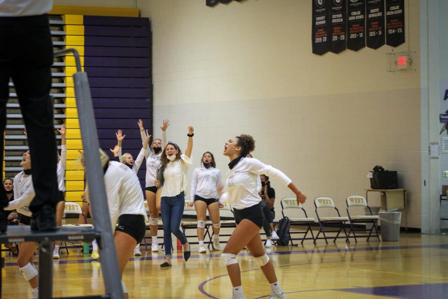 Sophomore Destiny Ndam-Simpson celebrates with the volleyball team during the Bellevue West vs Millard West on Sept. 24, 2020.