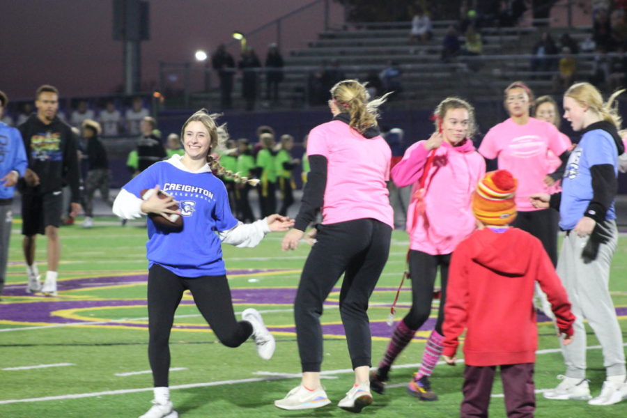 Freshman Anna Faiman runs away with the football during the Powderpuff game. 