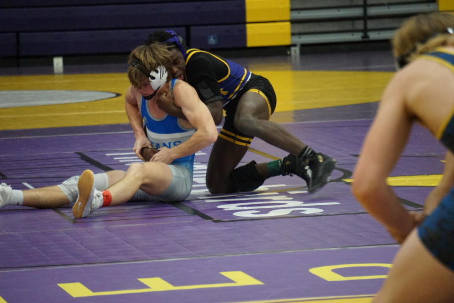 Sophomore Kenneth Bryant grabs hold of his opponent and takes control of the round.