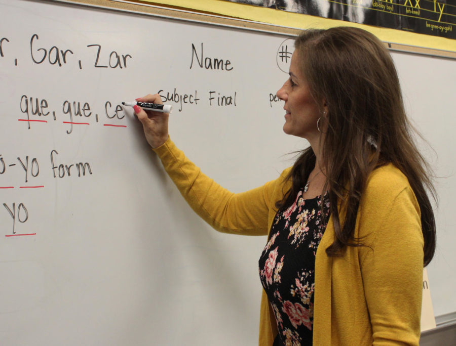 Machaella Fogarty writes on the white board to teach her class about accents.