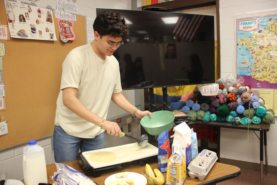 Senior Miguel Hernandez bakes crêpes for the members of the French NHS to enjoy while they work.
