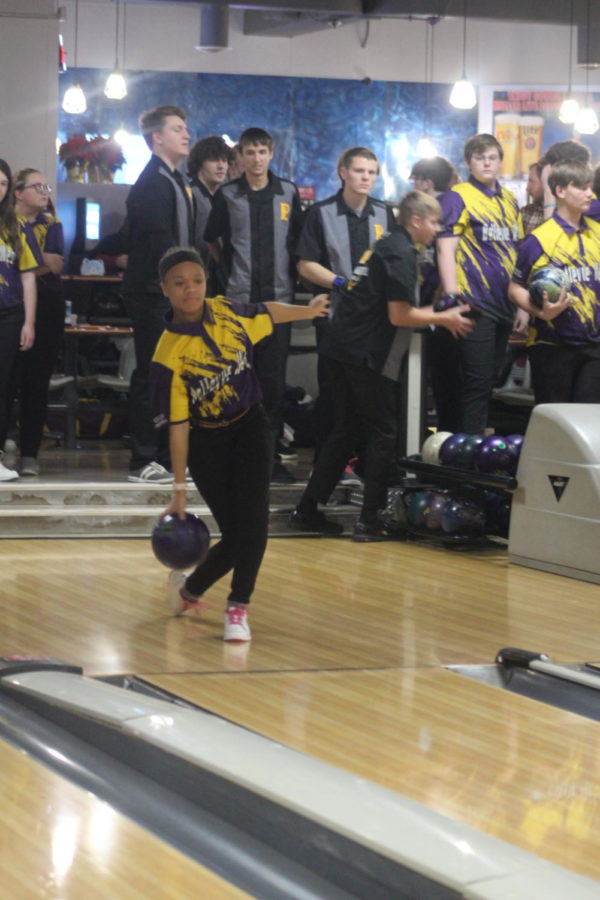 Senior Amaiah Slade bowls her bowling ball down the bowling lane. 