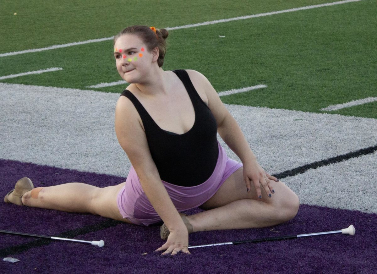 Sophomore Kinzie Danielson stretches before her performance.