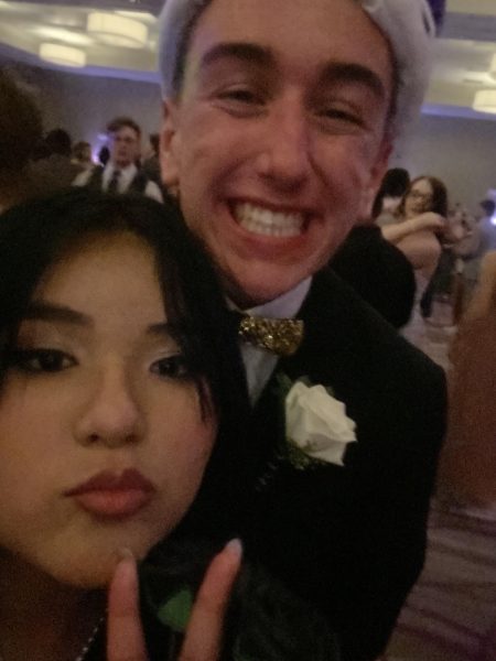 The Thunderbeat Videographer senior Athena Amaya flashes the peace sign with Prom King Andrew Hedin after his coronation.