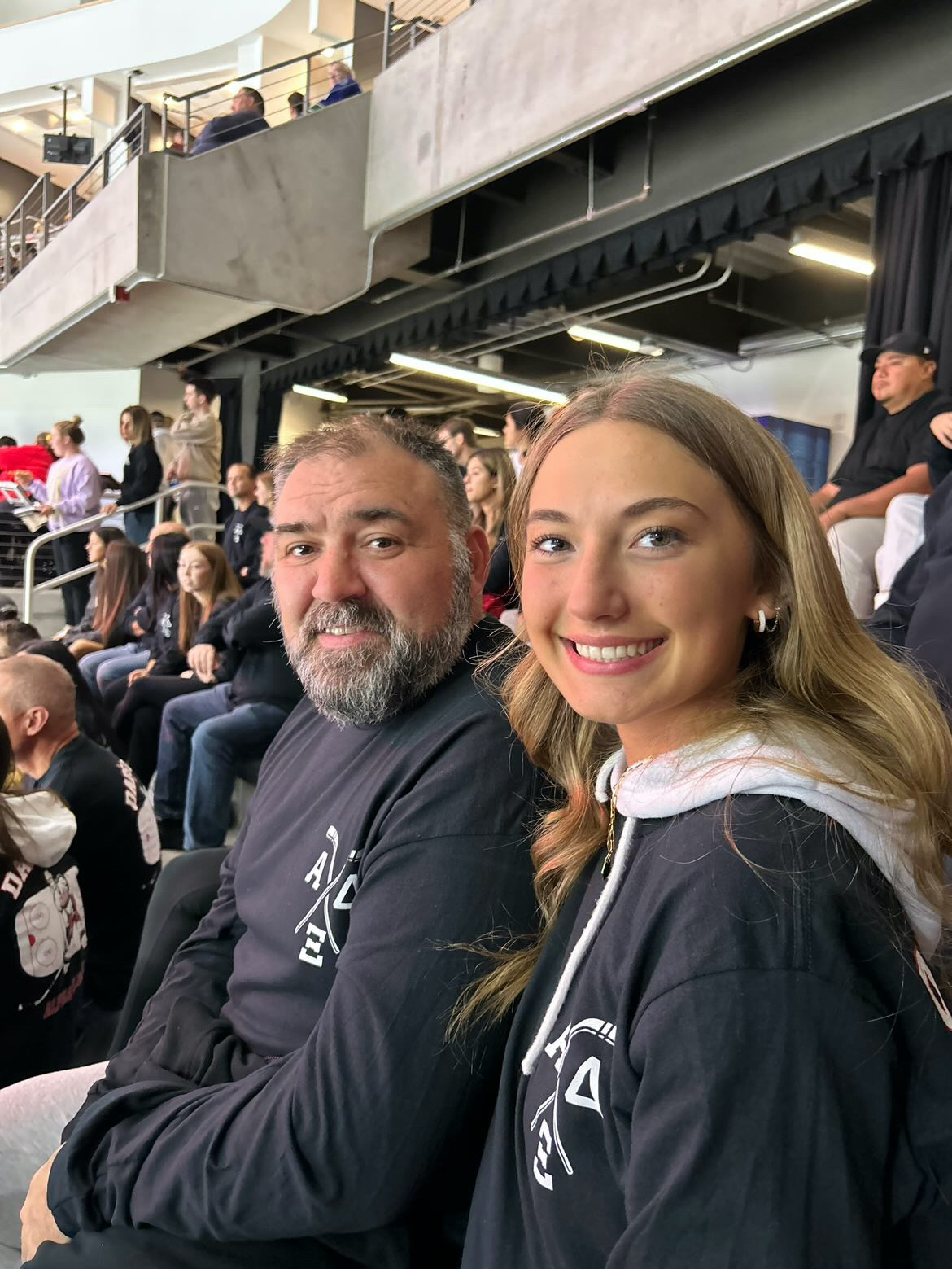 2022 alum Addy Gardner and her dad attend the Alpha Xi Delta sorority event and watch the hockey game. Photo provided by Addy Gardner.