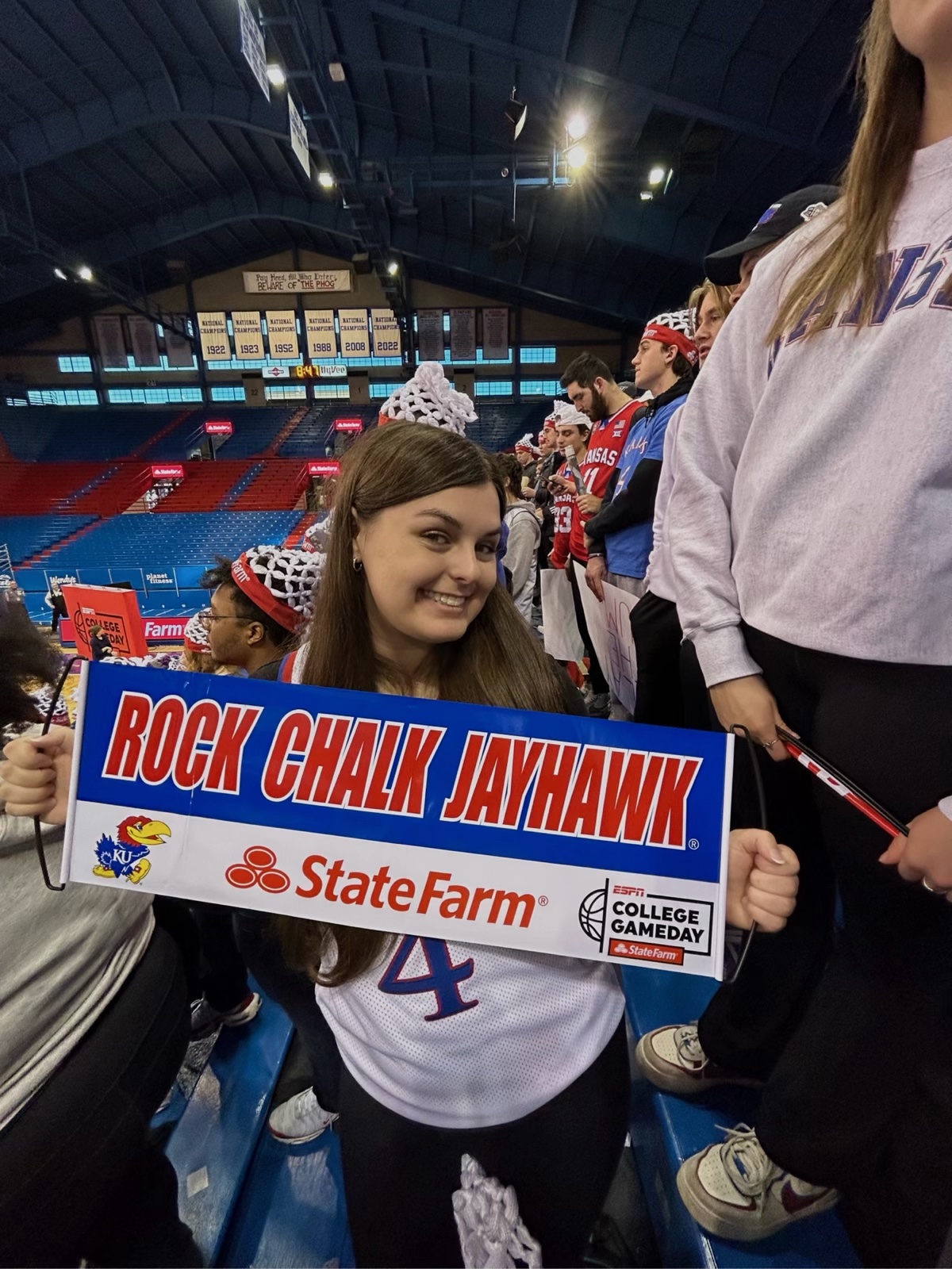 2022 alum Emily Mabbitt prepares to cheer on the jayhawks during a basketball game. Photo provided by Emily Mabitt.