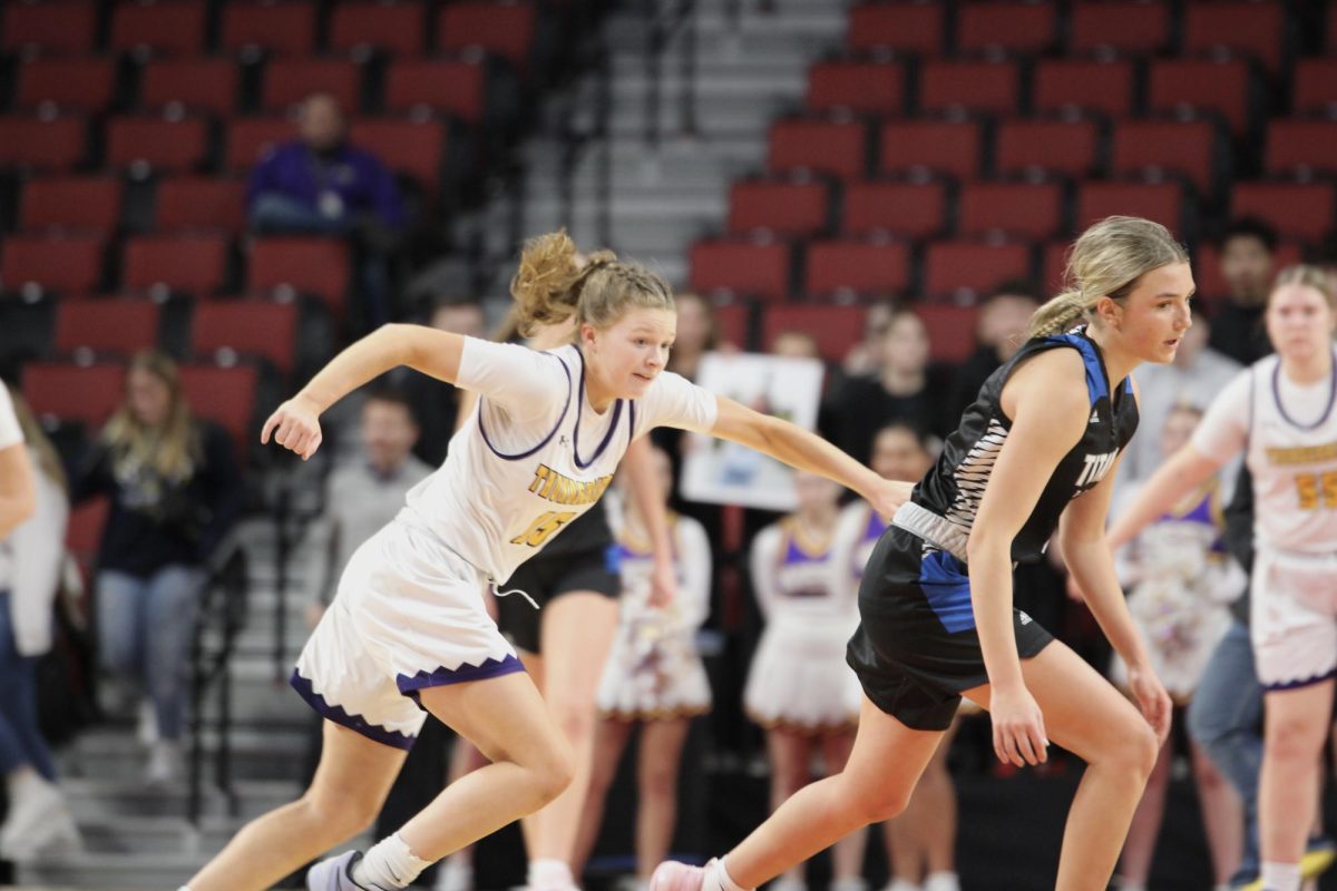 Senior Amy Oltman runs down the court during the state basketball tournament in 2024.