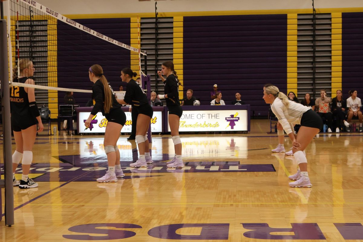 Seniors Anna Faiman, Michellle Burgess, Mia Toelle, and junior Shannon Fogarty line up for the opposing team's serve.