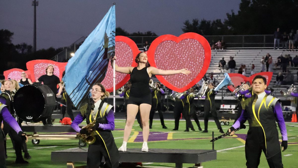 STRIKE A POSE. Sophomore Brooklyn Rodriguez poses with a flag. 