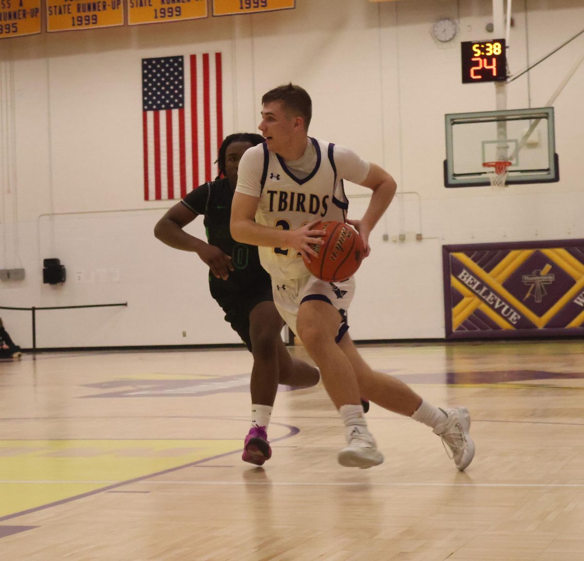 Junior Carsen Schultz dribbles the ball down the court.