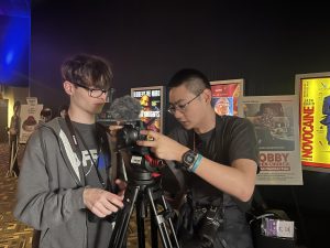 Seniors Lucas Pechacek and Zach Hayes set up a camera they will use to interview filmmakers at the Omaha Film Festival throughout the week.