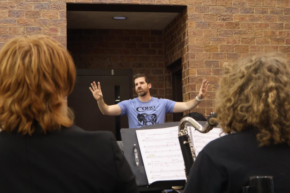 Orchestra conductor AJ Reimer stops the pit.