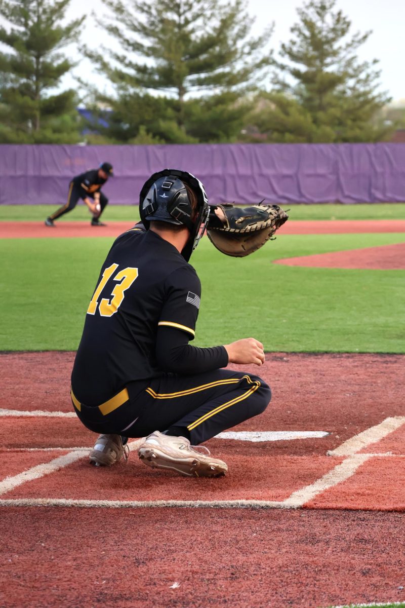 Senior Cole Madden catches a practice pitch before the game. 