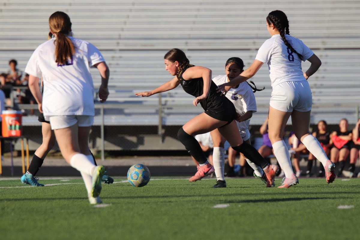 Junior Zoe Ryan kicks the ball towards the goal.