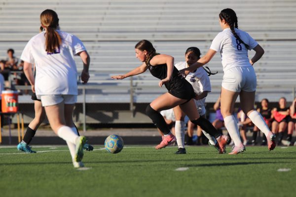 Junior Zoe Ryan kicks the ball towards the goal.