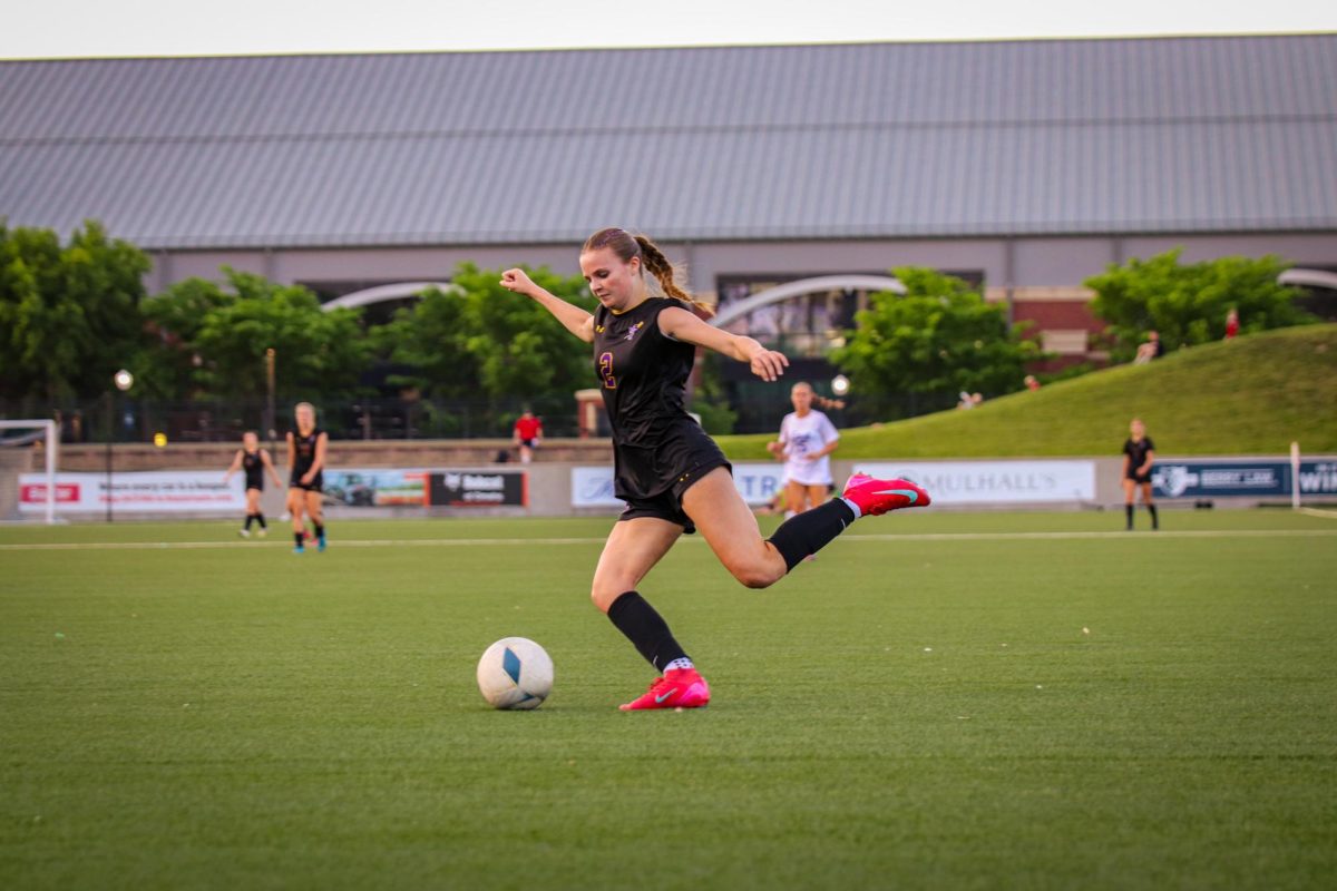 Junior Vanna Reitsma kicks the ball towards the goal in an attempt to score.