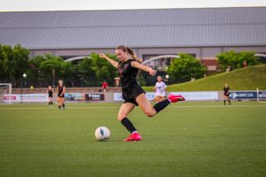Junior Vanna Reitsma kicks the ball towards the goal in an attempt to score.