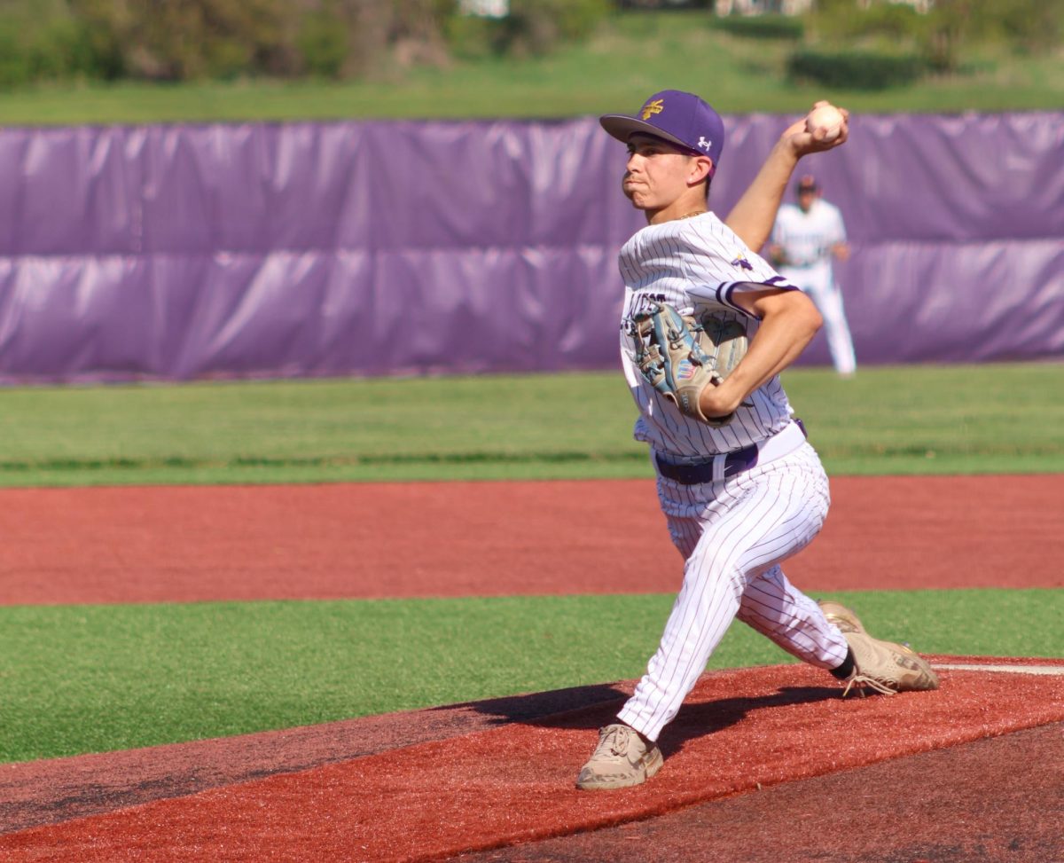 WIND-UP. Junior Joseph Hartin-Kovy strides off of the mound to deliver his pitch. 