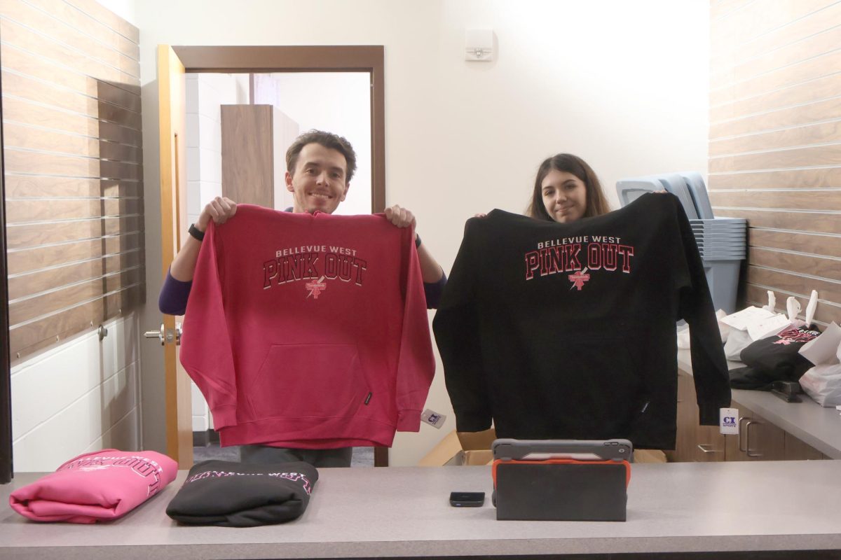 Business teacher Noah Graziano and junior Cheyenne Nickell sell Pink Out sweatshirts at the Bird House on Oct. 15 during lunch.