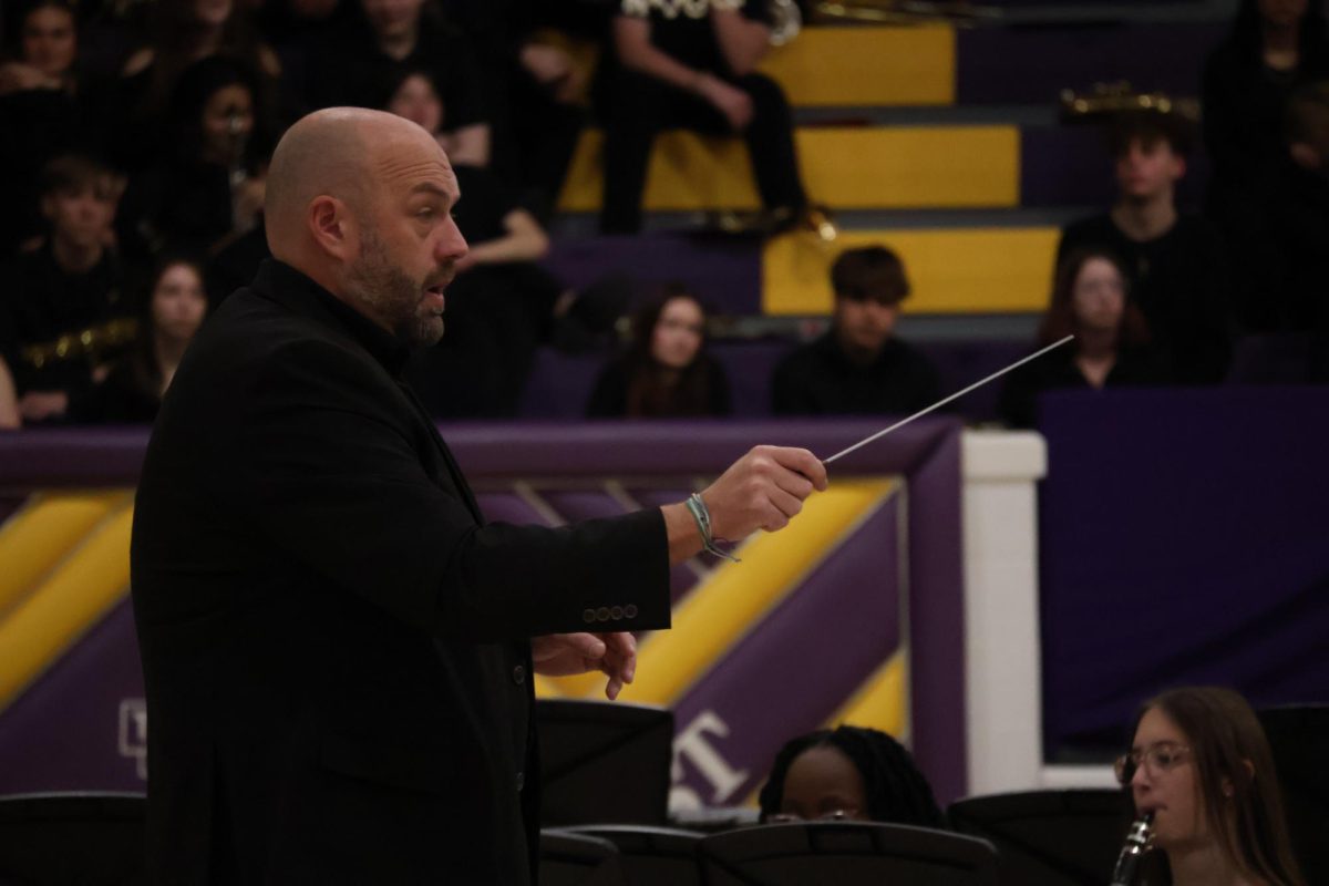 Band director Marques Eckhoff conducts the band at the Christmas concert. 