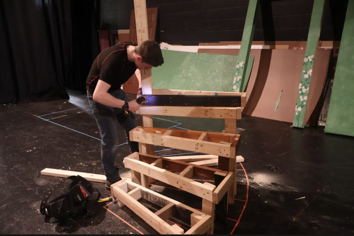 Senior Harris Stay builds a set piece for the school musical during his Theatre Production and Management class.