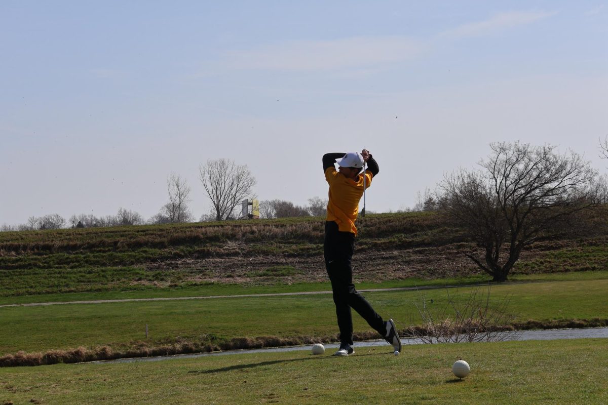 Senior Adam Williams finishes his practice swing.