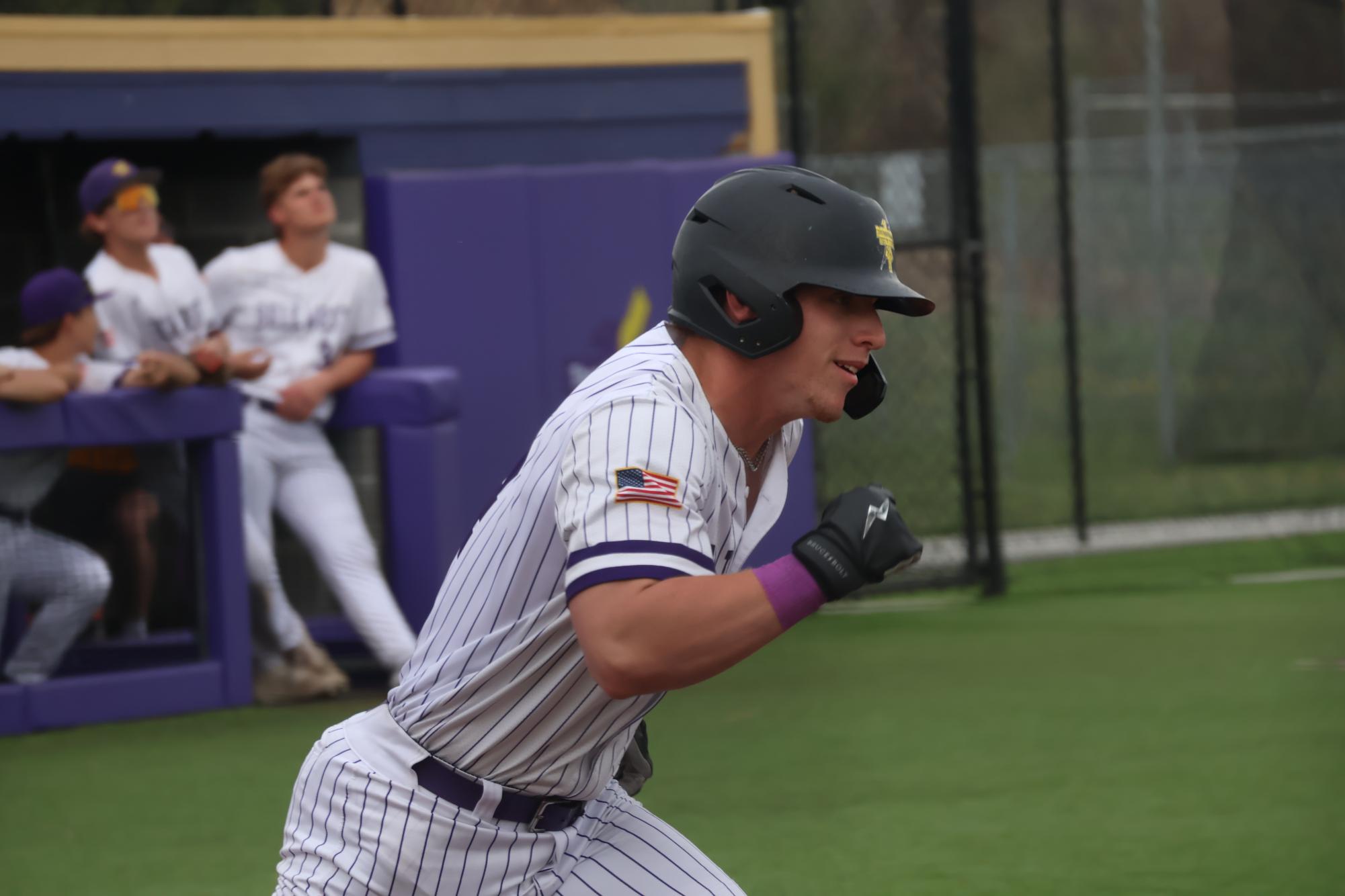 NEXT BASE. Senior Aiden Ensor runs to first base after a successful hit.