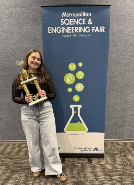 Senior Madeleine Blakely holds the Dow Award at the Metropolitan Science and Engineering Fair. Photo provided by Alex Cicero.