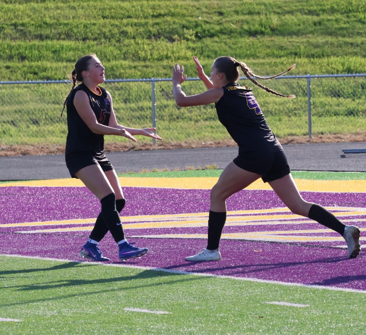 Senior Zoe Ryan and sophomore Yirah Sears celebrate after a goal.