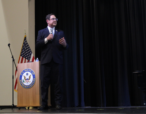 U.S. Rep. Mike Flood speaks to constituents at a town hall at Bellevue West's Thunderbird Performing Arts Center on July 7, 2026.